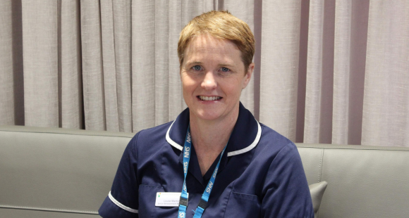 Louise Martin photographed in her navy work tunic and NHS blue lanyard