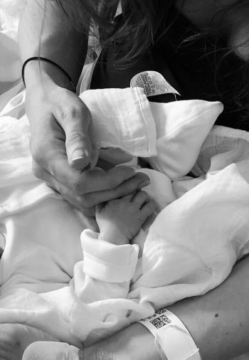 Katie holding her daughter Wren’s hand following he4r stillbirth.