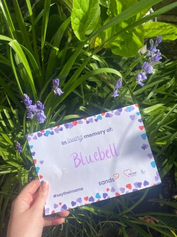 Kyle holding a sheet with Bluebell’s name after a lack of support following her death.