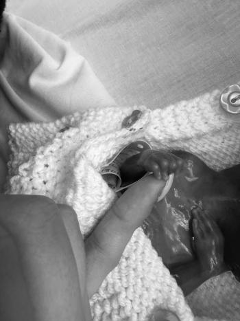  Sienna, a second trimester loss, holding a finger.