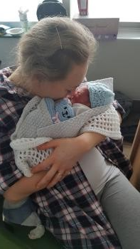 Jessica cuddling Jacob after his stillbirth.