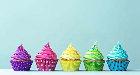 Line of five colourful cakes