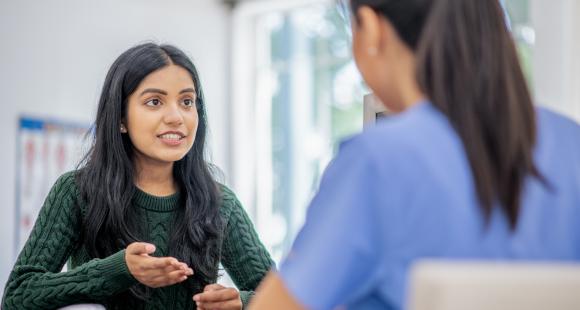 Volunteer speaking to health professional