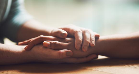 An image of two hands holding one another
