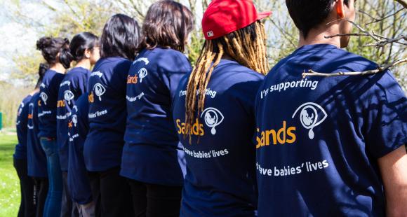 Image of people facing forwards with the Sands t-shirts on
