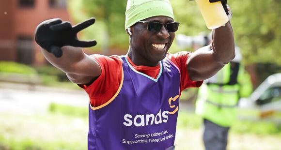 A man running with hands in the air