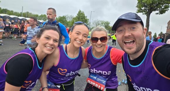 Four people smiling