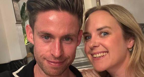 A couple smile at the camera after sharing their IVF journey and the news they had a missed miscarriage.