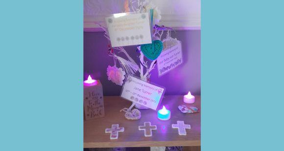 Image of a tree of remembrance which has cards and baubles hanging on it