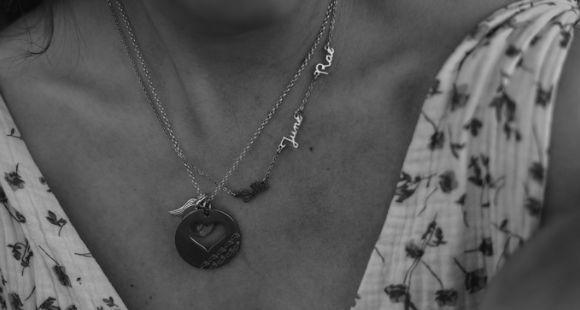 A black and white picture of a necklace with the names June who was a TFMR and Rae
