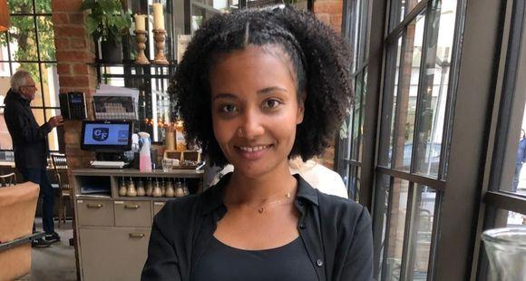 A lady smiling at the camera talking out as part of Black Baby Loss Awareness Week.
