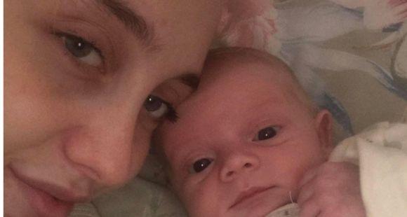 A lady and her small baby boy look at the camera