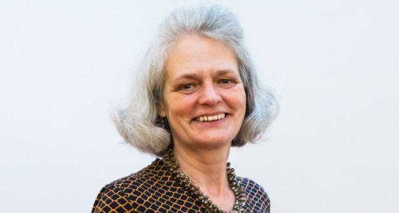 Sands' Chief Executive Clea Harmer is smiling looking at the camera and wearing a diamond print dark brown blouse and brown necklace