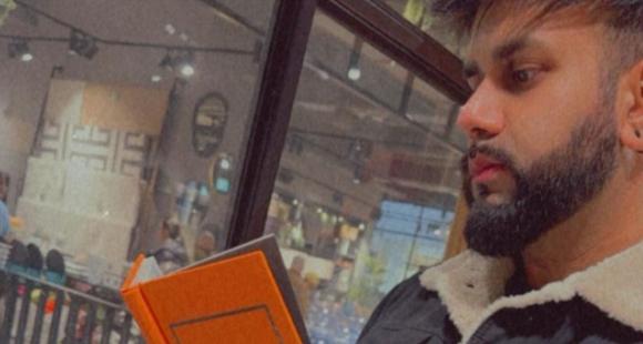 Saj reading from a book