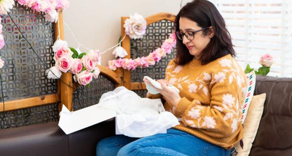 Lady sat on the sofa going through a Sands Memory Box