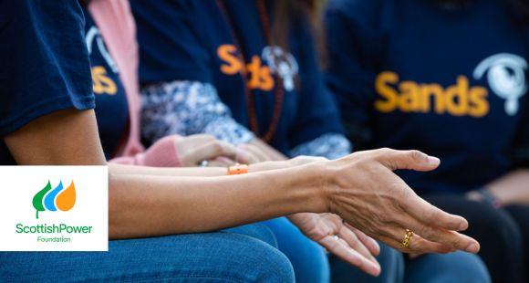 Ladies sat together with Sands t-shirts on