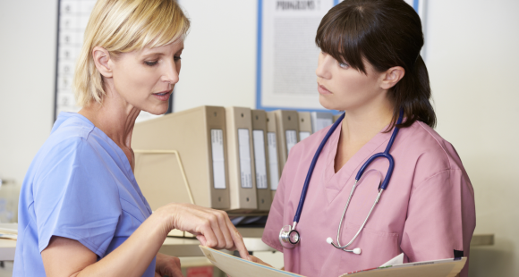 Two female health professionals talking