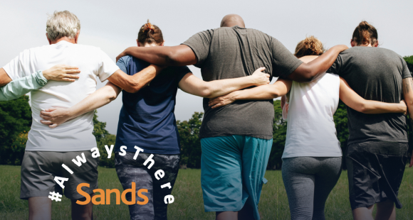 Sands Always There - people with arms around each others shoulders
