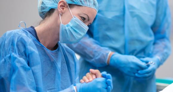 Supportive healthcare professional holds woman's hand
