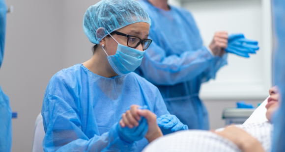 midwife holding a patient's hand