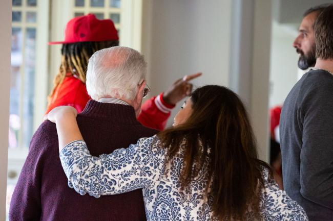 Woman with her arm around an older man during a Sands support group gathering