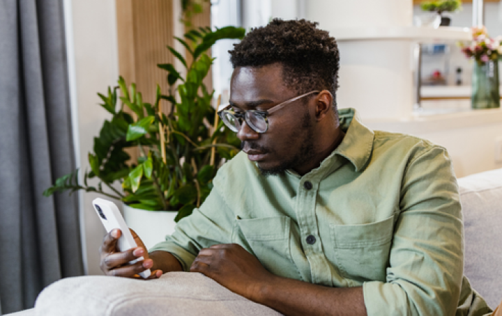 Man sat on his phone looking for support