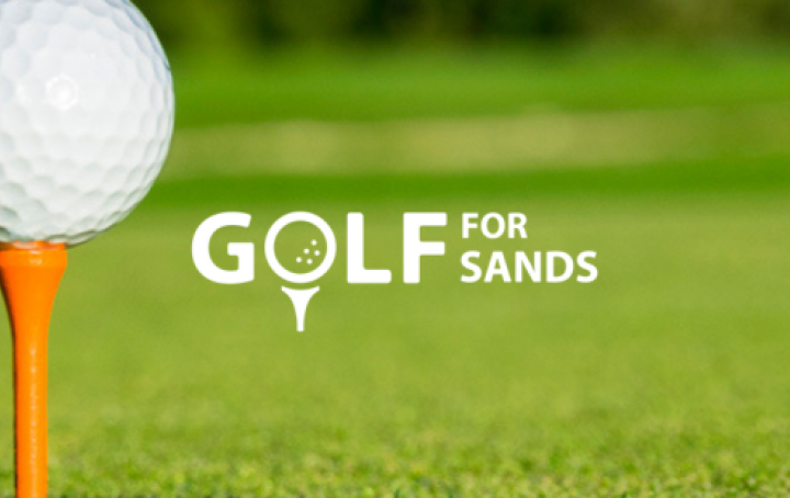 White logo text in front of a green fairway, alongside white golf ball on an orange tee