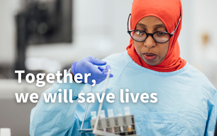 a woman in PPE working in a lab