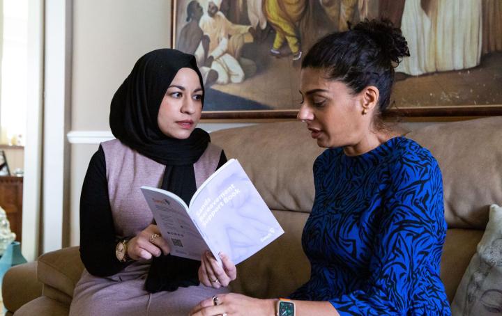 Ladies sat together with bereavement support book