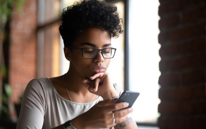 Lady scrolling through her phone looking for support