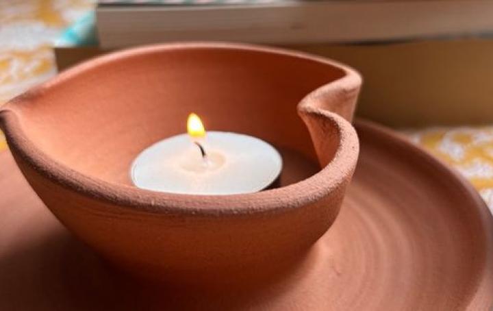 heart shaped diya lit with a tea light candle