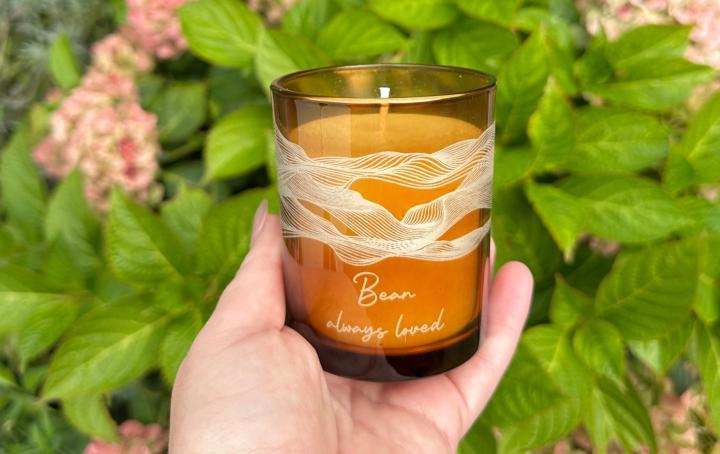 Image of a hand holding the personalised charity candle in aid of Sands