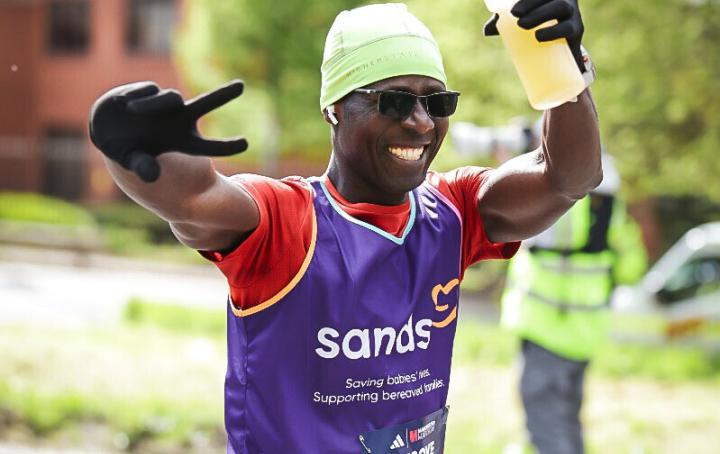 A man running with hands in the air