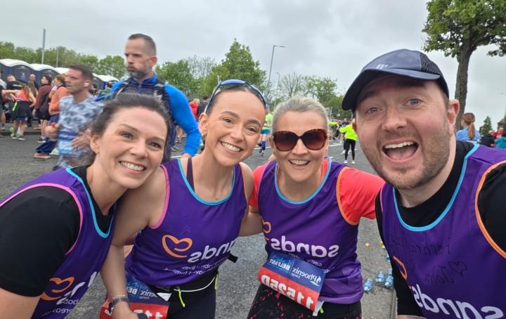 Four people smiling