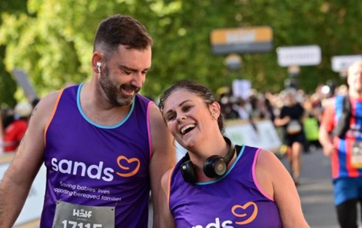 A man and a woman laughing and walking