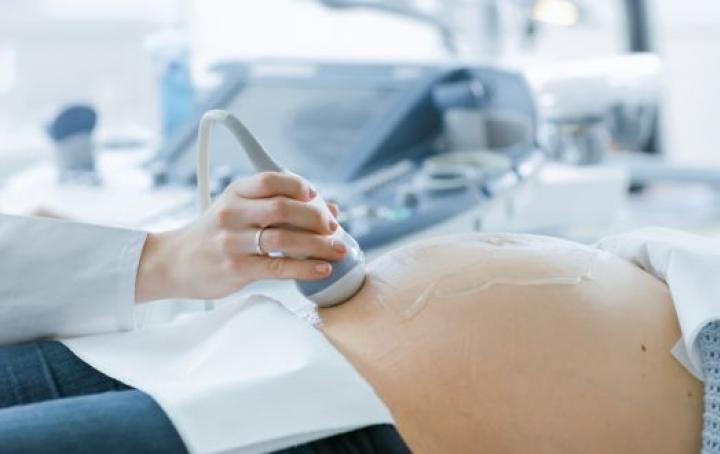 Image of pregnant woman receiving a scan