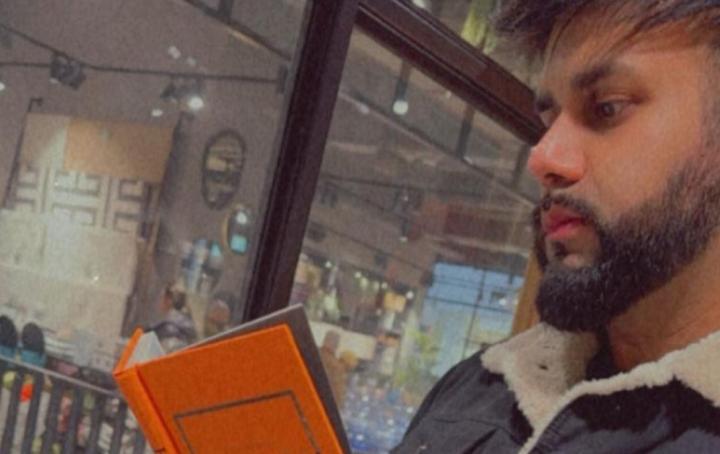 Saj reading from a book