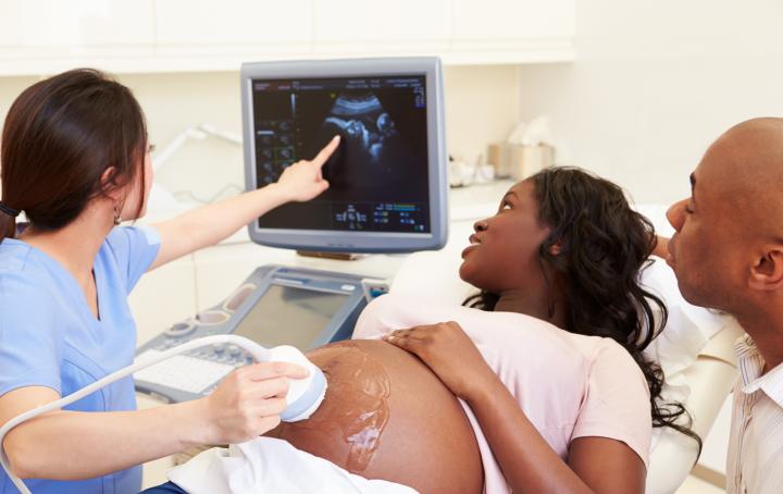 Black mother having sonogram with partner