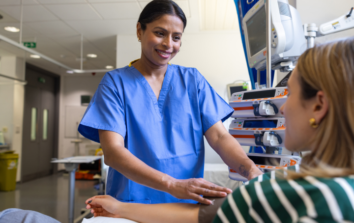 Image of pregnant woman and a doctor showing her a picture of a baby scan