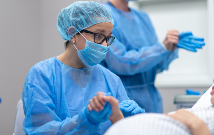 midwife holding a patient's hand