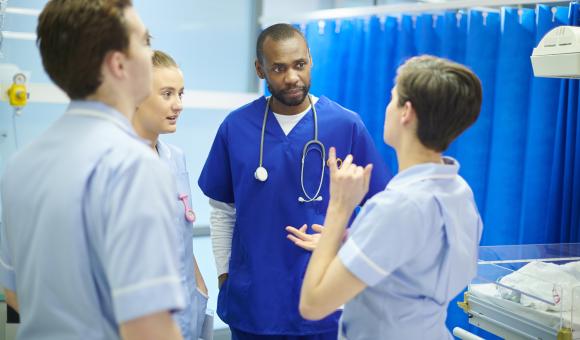 A group of healthcare professionals stood together and talking